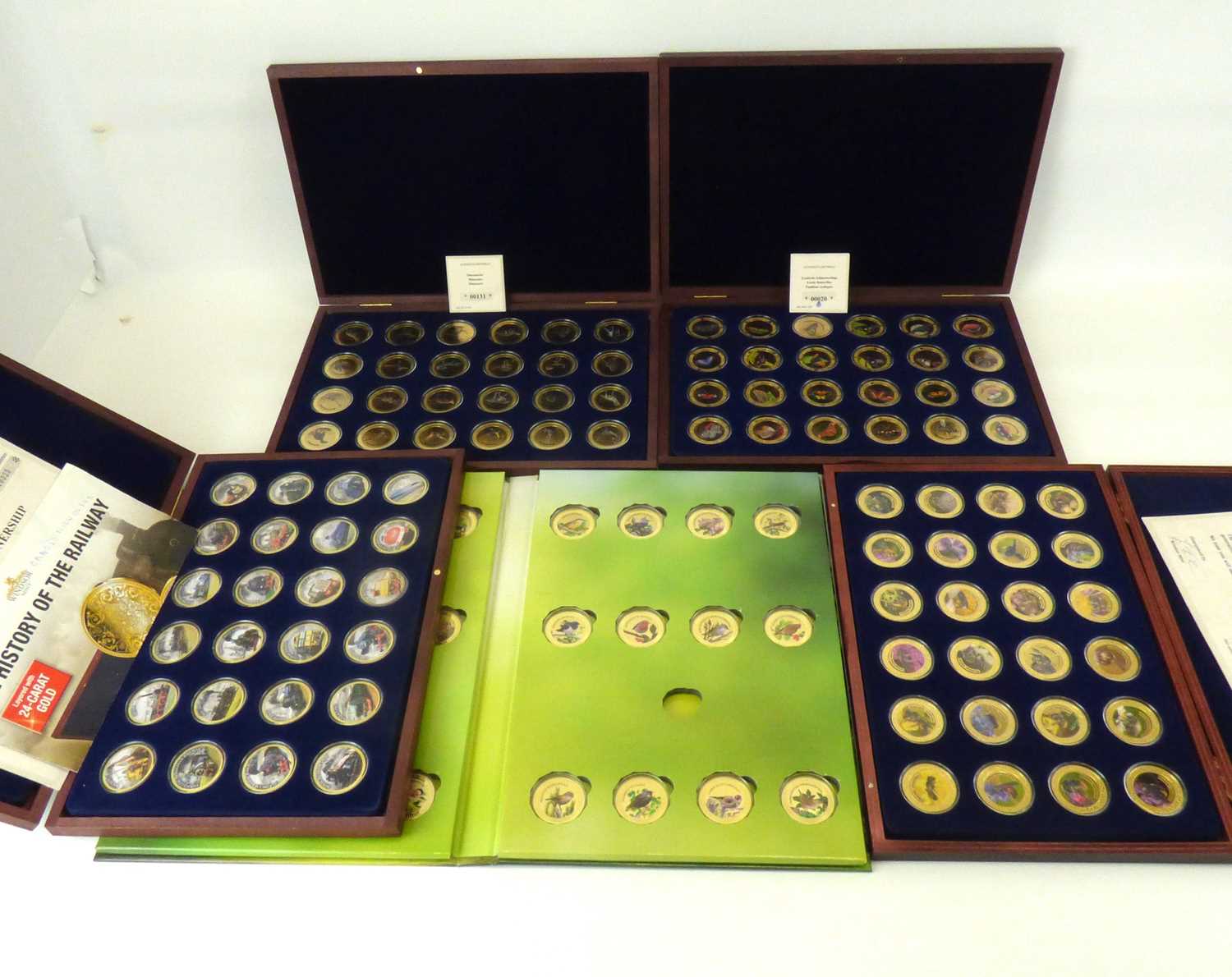 WINDSOR MINT; four cased sets, each containing twenty-four encapsulated photographic image coins,