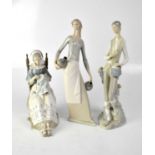 LLADRO; two figures, seated lady in period costume (af), a young gentleman leaning against tree