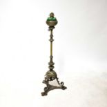 An ornate 19th century cast metal standard lamp with brass wrythen twist column above stepped