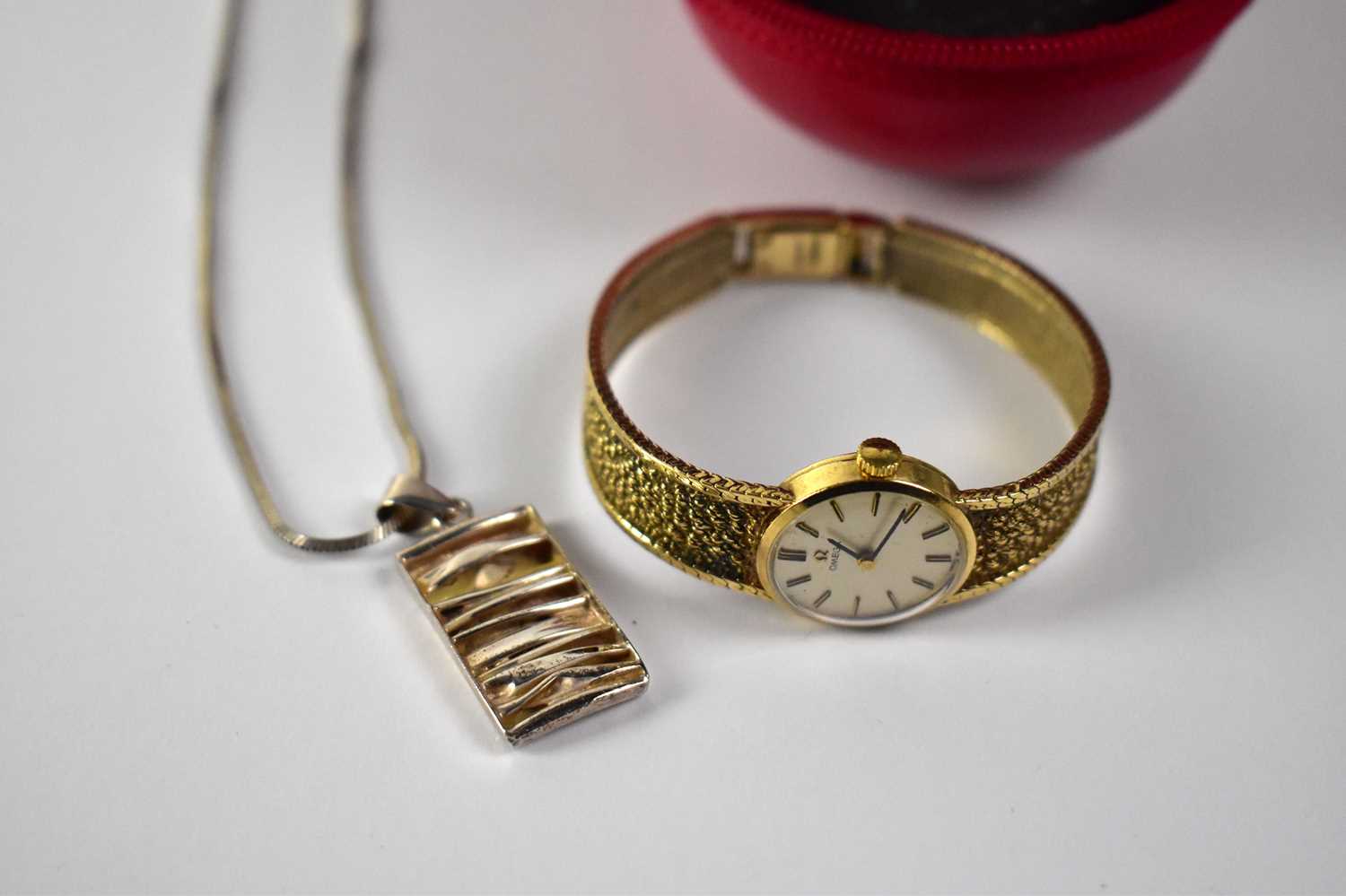 OMEGA; a ladies' 9ct gold wristwatch, the gilded dial set with baton numerals, on a 9ct yellow