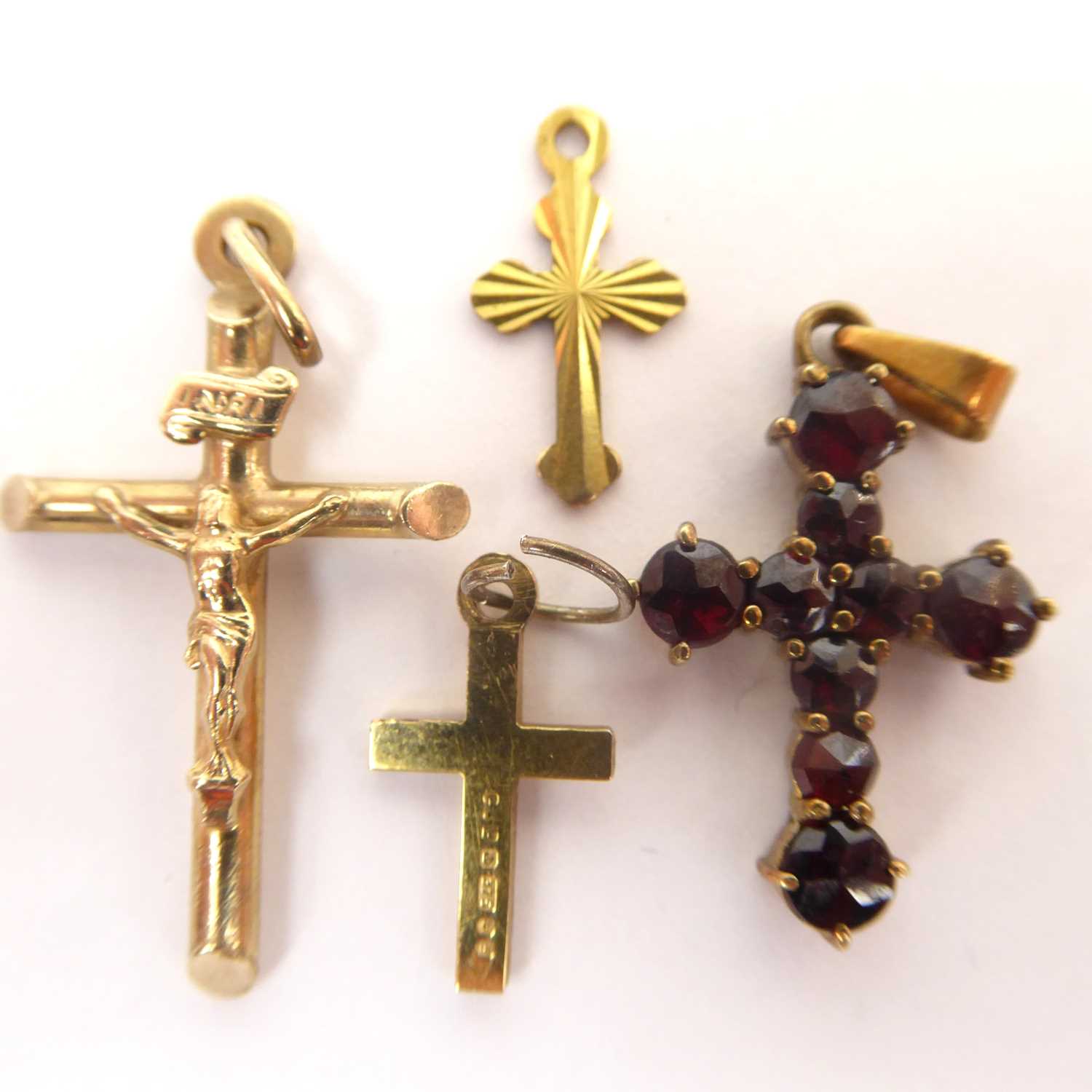Four 9ct gold crosses to include one encrusted with tiny claw set diamonds, with necklace hoop,