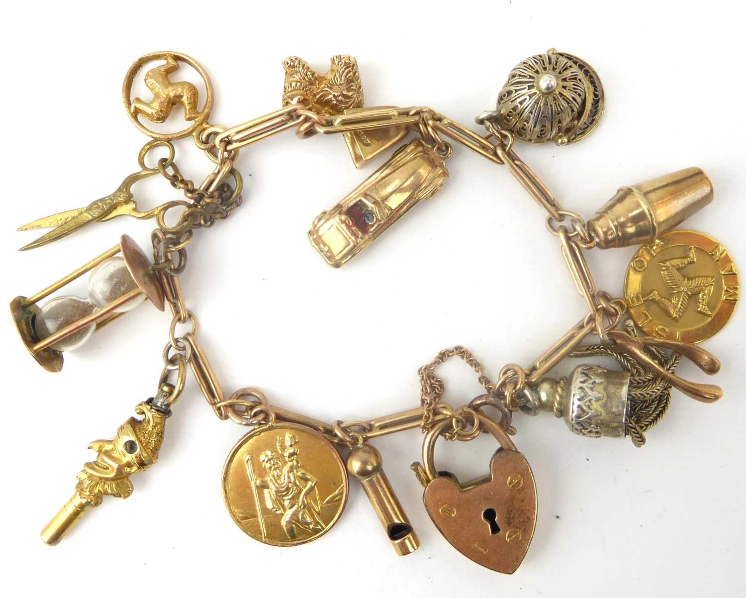 A vintage 9ct gold charm bracelet with six gold charms and eight unmarked charms, including a sports