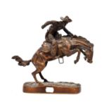 AFTER FREDERIC REMMINGTON; a bronze sculpture 'Bronco Buster' on naturalistic base.Height 26cm