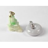 A green jade pendant in the form of a bird on rocky outcrop and a grey jade polo pendant.Qty: 2