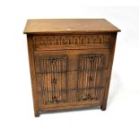 An early 20th century oak priory-style four-drawer chest with egg and dart decoration to the top