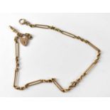 A 19th century 9ct rose gold watch chain with elongated and circular links, with 9ct gold heart-