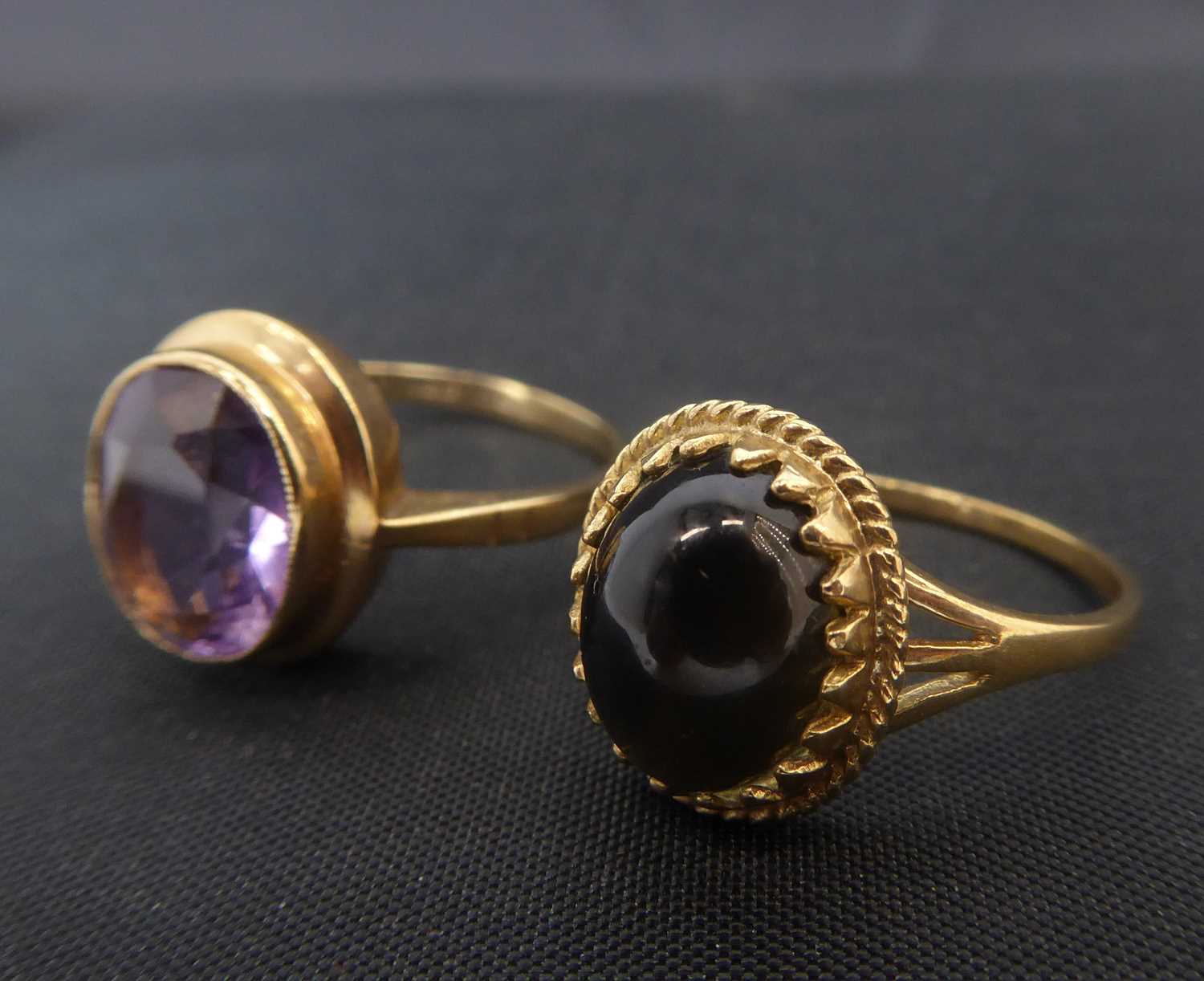 Two 9ct gold dress rings comprising a smoky quartz cabochon in 9ct gold oval mount, split shoulders,