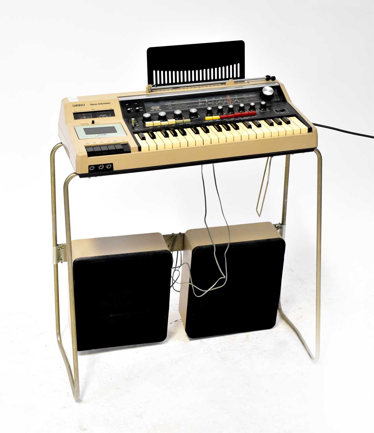 A Sankei Stereo Entertainer comprising a keyboard with stereo radio and cassette player, on a