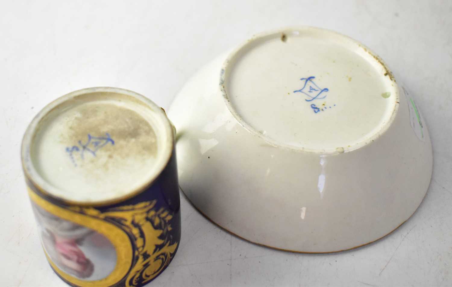 SÈVRES; a circa 1754 coffee cup and saucer, with cobalt blue ground and vignette of a lady in 18th - Image 2 of 2