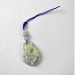 A green and lavender multicoloured oval jade pendant caved with a dragon, suspended by three