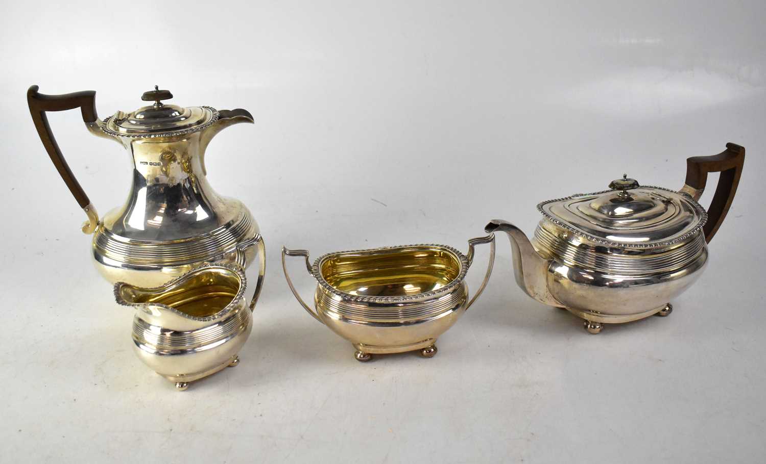 JAMES DIXON & SONS; a George V silver four-piece tea set of oval form with reeded decoration and