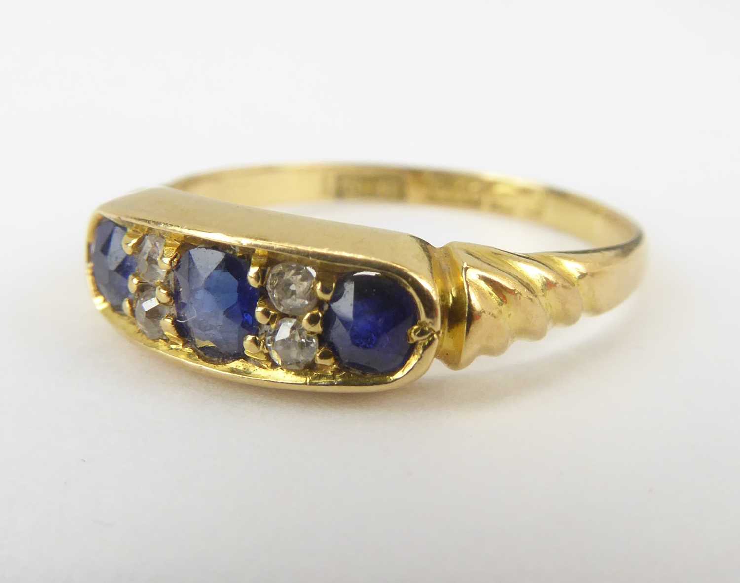 Two 18ct gold dress rings comprising an example with three channel set sapphires separated with - Image 2 of 6