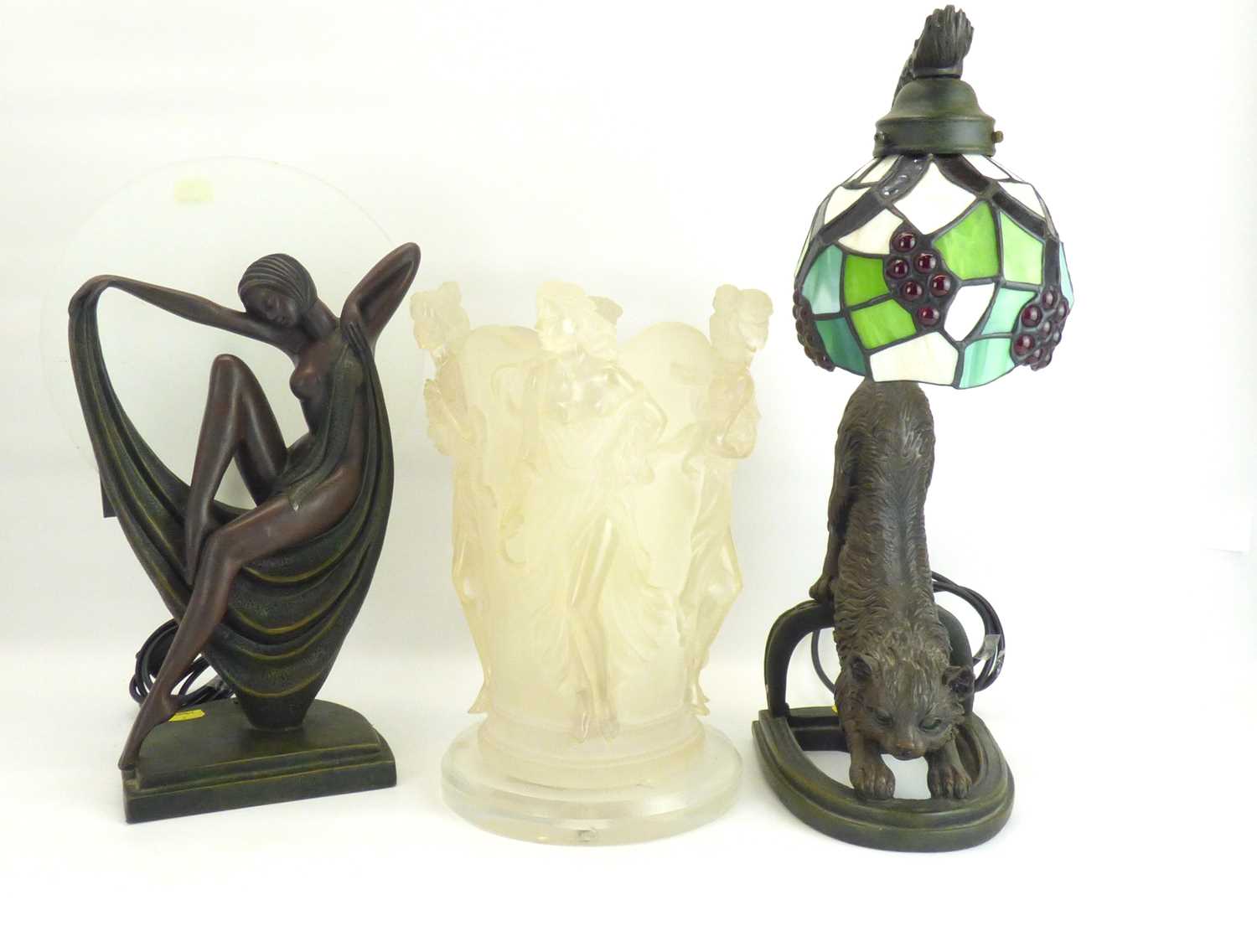 Three modern reproduction table lights to include an Art Deco dancing figure with circular glass