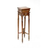 A 20th century mahogany jardinière stand with carved leaf decoration to slender tapering legs and