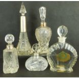 Five early 20th century cut glass dressing table perfume decanters of various sizes and shapes,