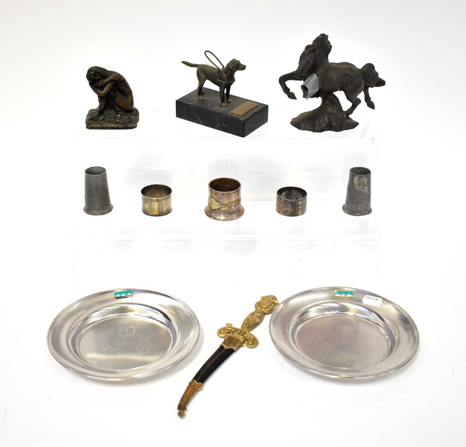 A collectors' lot comprising a bronzed model of a dog raised on stand, a sword-form letter opener,