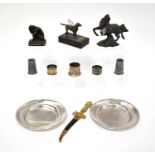 A collectors' lot comprising a bronzed model of a dog raised on stand, a sword-form letter opener,
