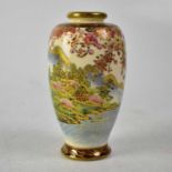 An early 20th century Satsuma baluster vase with polychrome enamelled scene of idyllic village