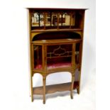 An Arts & Crafts mahogany side cabinet, the upper section with open shelf and bevel edged mirror,