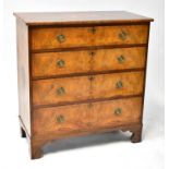 A 19th century walnut chest of four long graduated drawers, raised on bracket feet, with inlaid