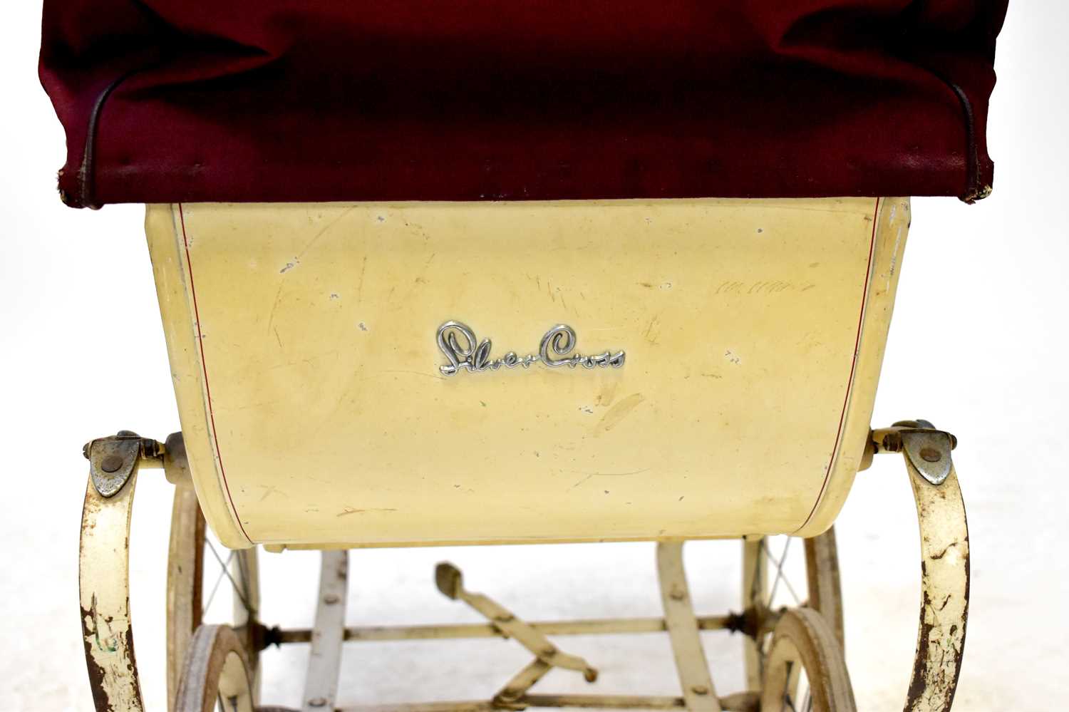 A vintage mid-20th century Silver Cross dolls' pram, cream body with maroon hood and apron.Condition - Image 3 of 3