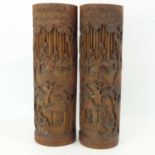 A pair of 20th century carved bamboo brush pots with carved figures in houses and within a bamboo