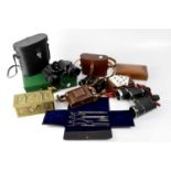 A collectors' lot comprising three pairs of binoculars, a Zeiss Ikon camera, a leather card case,