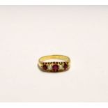 An 18ct gold ring set with three rubies and two diamonds in claw settings, stamped 18, approx. 4.