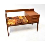 A mid-20th century teak telephone table with a pair of integral drawers and seat.63 x 90 x 42cm.