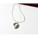 GEORG JENSEN; a sterling silver 1997 Designer Pendant of the Year, on chain, with leaflet and