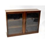 A 1930s mahogany glazed bookcase or display cabinet of rectangular form, on a plinth base.92 x 135 x