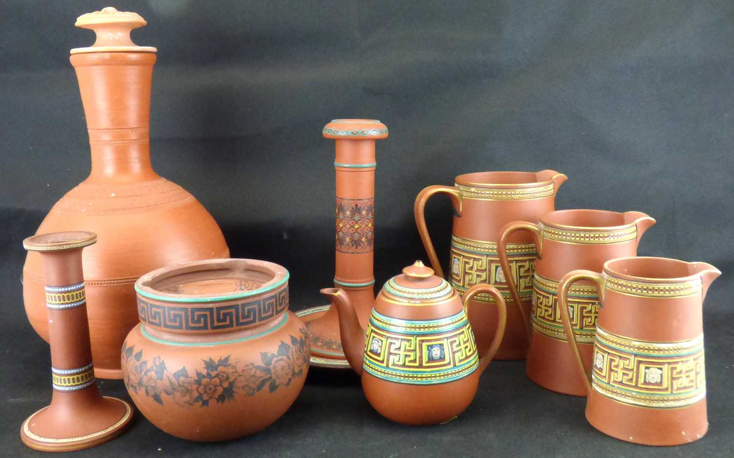 Nine pieces of 19th century terracotta, mostly decorated with bright Classical enamels, to include a