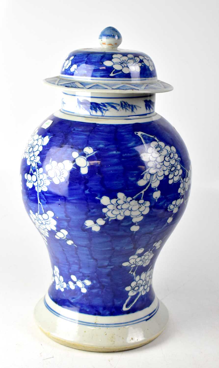 A 19th century Chinese blue and white baluster vase with cover, with prunus blossom decoration