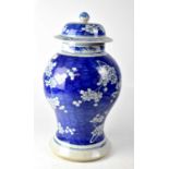 A 19th century Chinese blue and white baluster vase with cover, with prunus blossom decoration