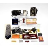 A collectors' lot to include a cased Brownie camera, a cased Pentax Zoom 90 camera, a cased Konica