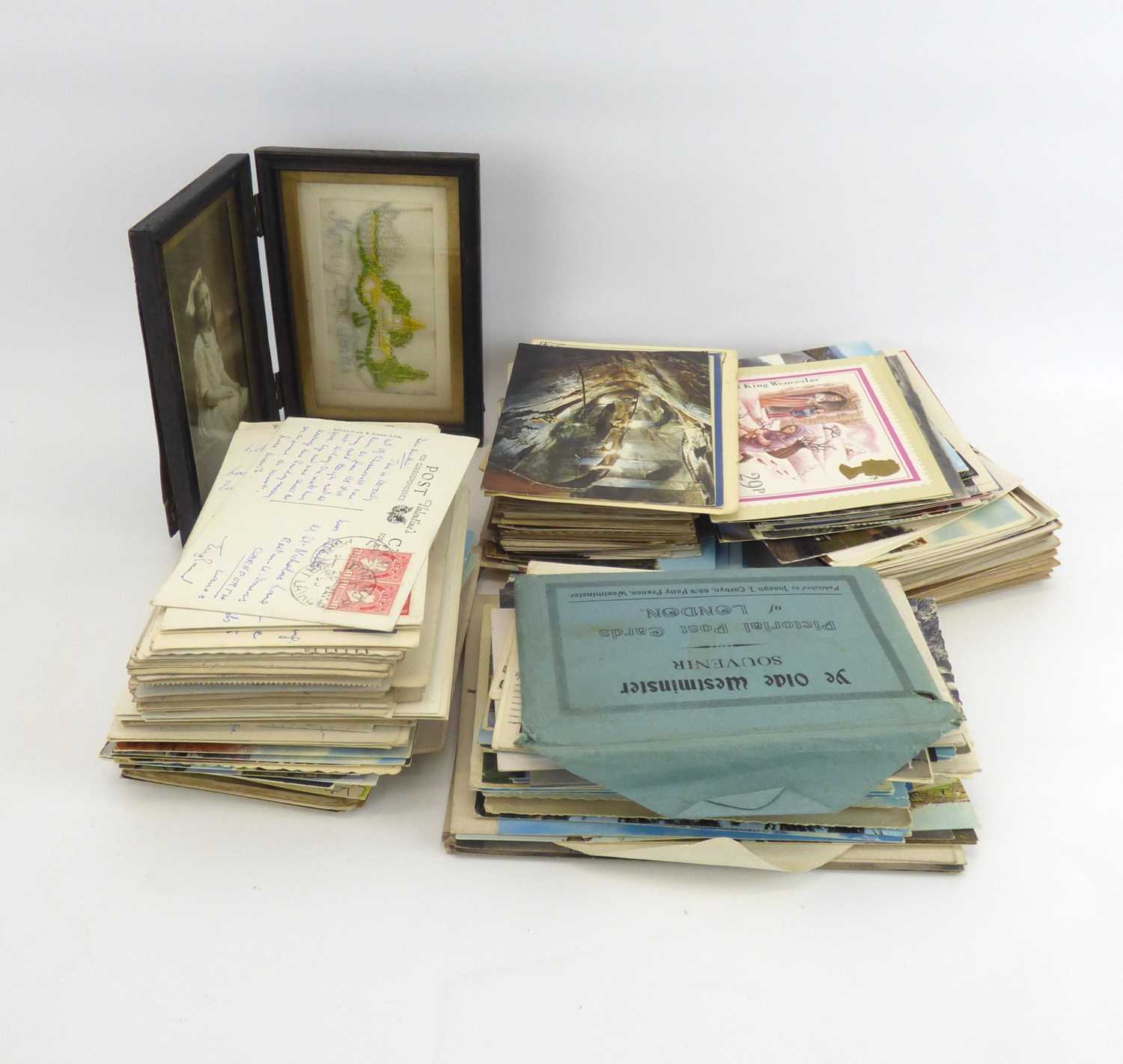 A quantity of mostly vintage and early 20th century postcards to include military themed examples,