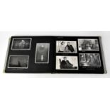 A mid-20th century photograph album containing many black and white photographs, family images,