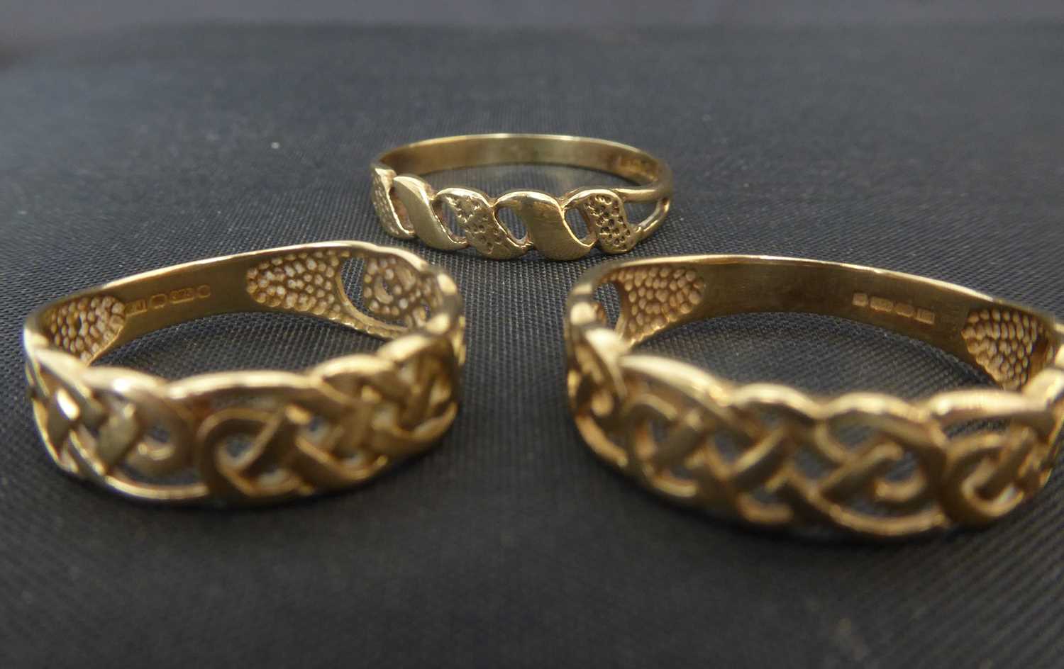 Three 9ct gold openwork Celtic design rings, two size N and the other size H, approx combined 3.4g.