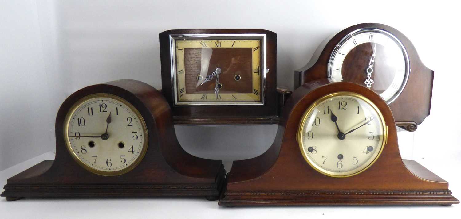 Four mantel clocks to include three oak cased examples comprising a Napoleon hat shape example, with