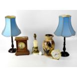 A pair of mahogany column table lamps to stepped circular base, with blue silk-effect fabric shades,