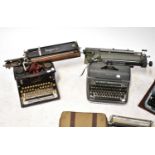 Four vintage typewriters comprising two Imperial models, one in a suitcase-type fitting, an