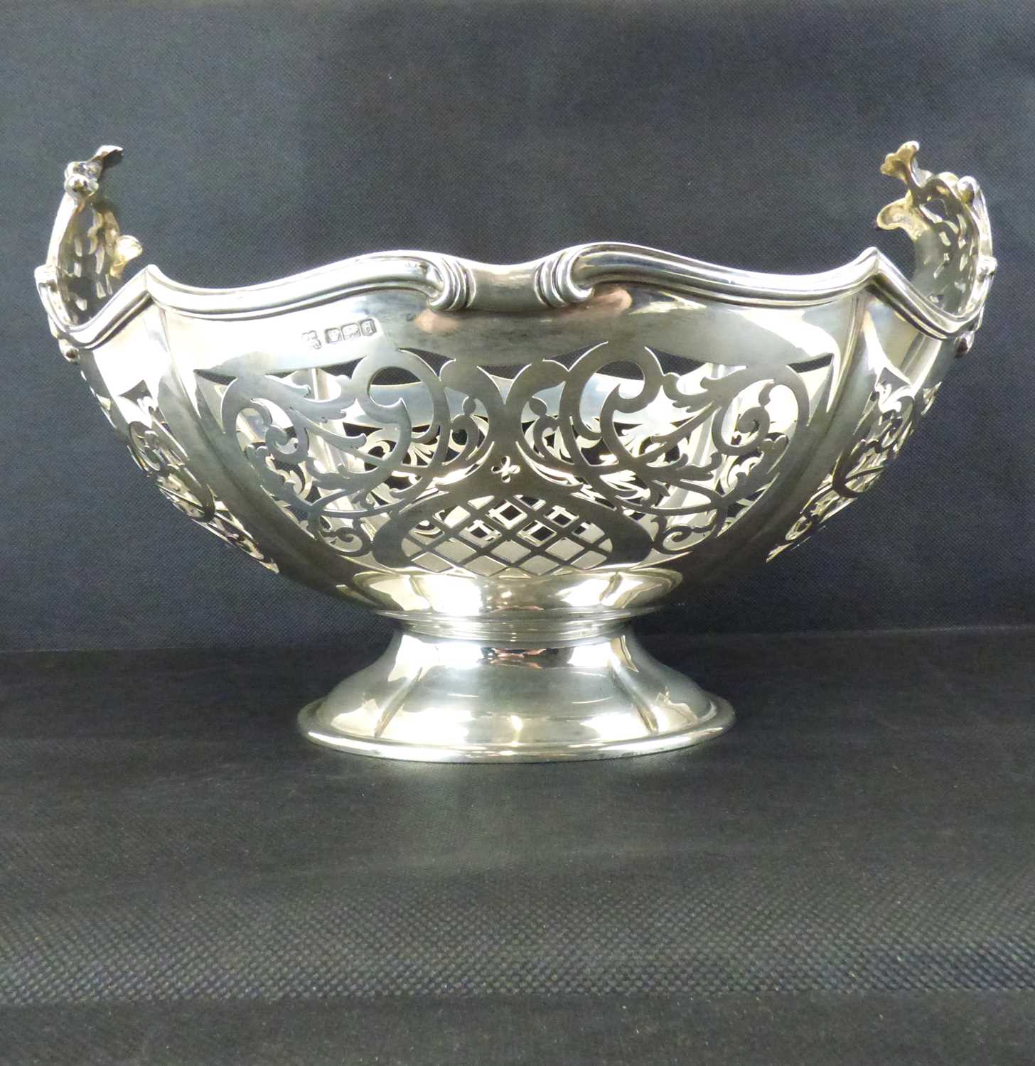 A large and impressive George V hallmarked silver fruit bowl with scroll and swagged shaped rim,