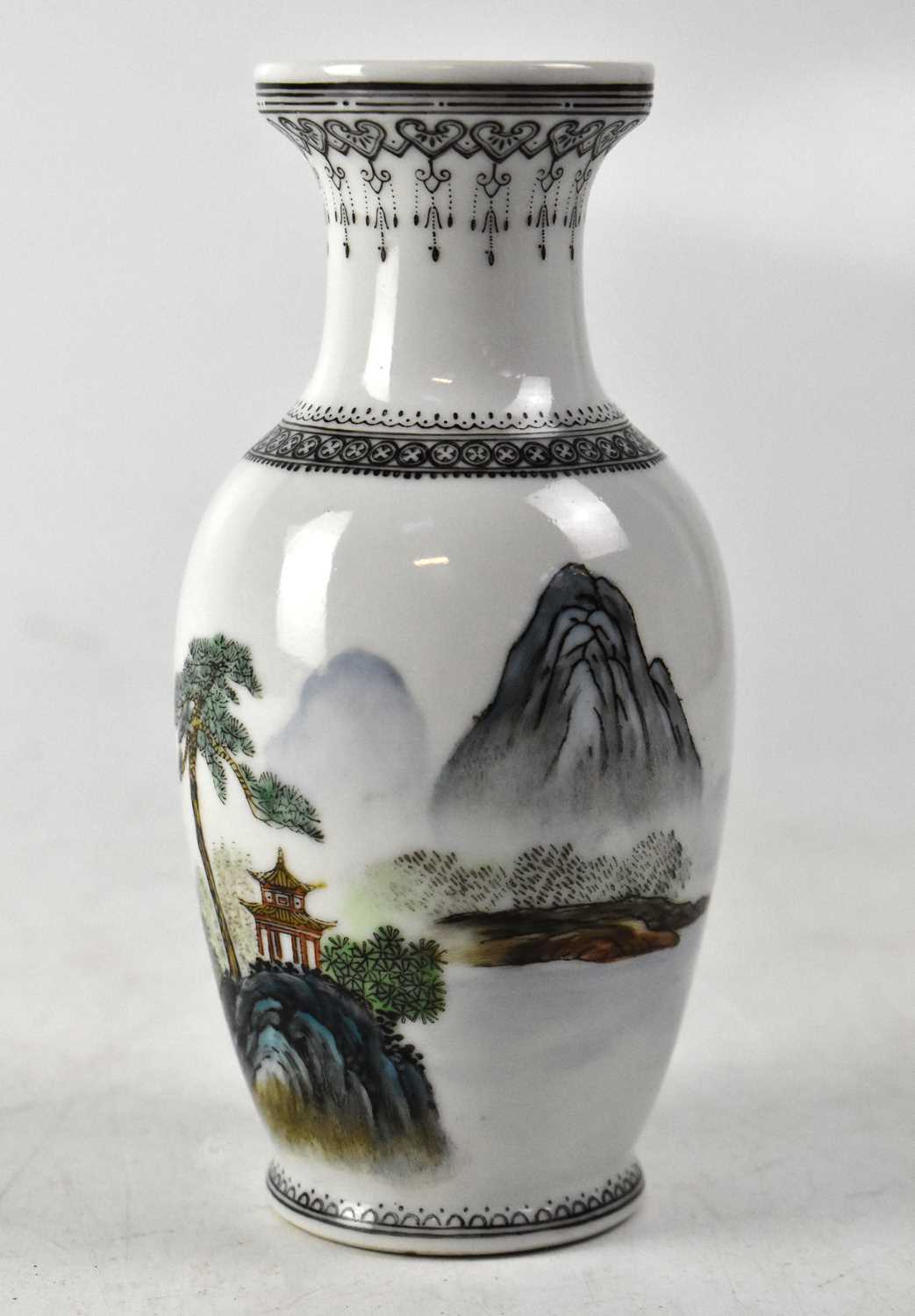 A 20th century Chinese baluster vase, white ground with polychrome scenic decoration, pagoda,