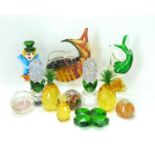 Twelve items of decorative art glass to include a group of three graduated pineapples with amber