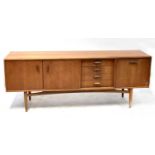 G-PLAN; a late 1960s/early 1970s teak sideboard with double-door cabinet, a bank of four small