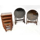 A Chinese carved hardwood circular tilt-top table with gateleg base, the top depicting junks, with