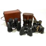 A pair of French lacquered brass binoculars engraved 'Avia', in leather case, with three further