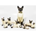 A model of a fireside Siamese cat, numbered 2139, height 35cm, together with seven Beswick and Royal