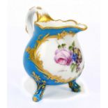 SEVRES; a 19th century hand painted footed cream jug, the central cabochon set with floral detail