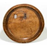 A 19th century fruitwood dough bowl of circular form with old patch repairs, diameter 50cm.